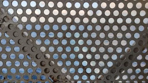 The surface of perforated metal. Stock Photos