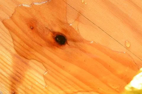 Surface of a rectangular wooden board with wavy lines and water. Stock Photos