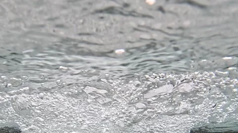 Surface ripples and bubbles forming on flowing water Video stock 317123460
