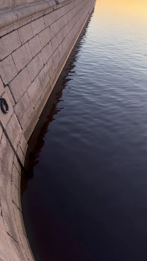 Surface of river water with ripples and slow flow near stone old bridge Stock-Footage 329678564