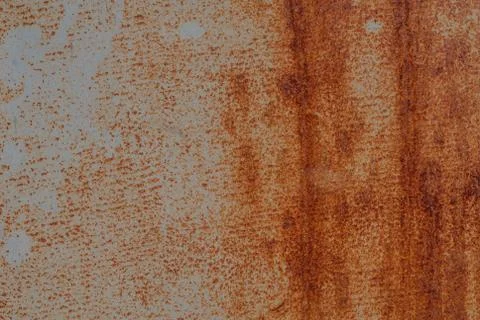 Surface of rusty iron with remnants of old paint, texture background Stock Photos