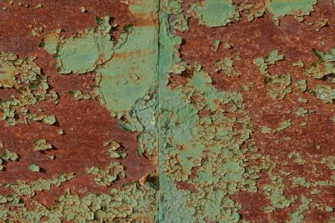Surface of rusty iron with remnants of old paint, green texture background Stock Photos
