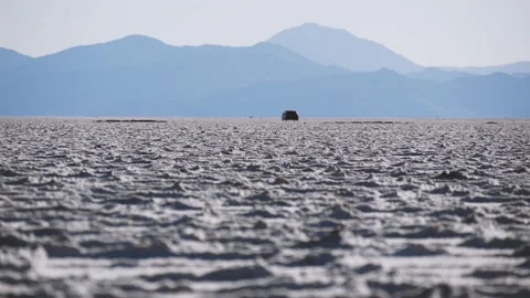 Surface With Saline Deposits In Salt Flats With A Passing Car In The Distance Stock Footage 168139856