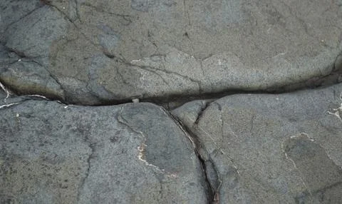 The surface of the stone is covered with cracks, texture Stock Photos