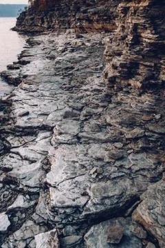 Surface of an stone wall. Black Stone background. Rock texture. Rock pile bac Stock Photos