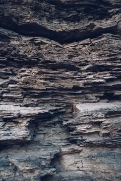 Surface of an stone wall. Black Stone background. Rock texture. Rock pile bac Stock Photos