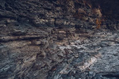 Surface of an stone wall. Black Stone background. Rock texture. Rock pile bac Stock Photos