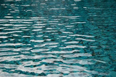 Surface of the swimming pool. Blue water texture for background. Stock Photos