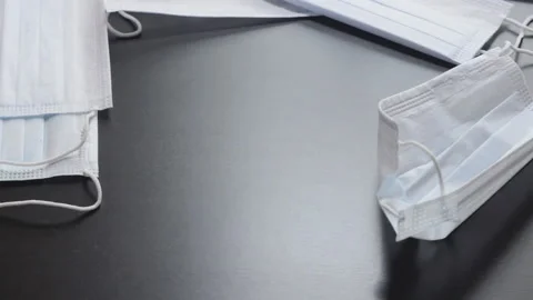 The Surface Of The Table Is Covered With A Layer Of Protective Medical Masks Video stock 140262637