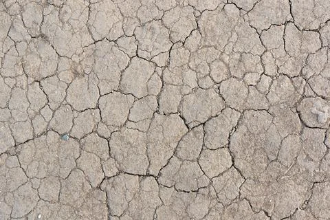 Surface texture of cracked earth soil during drought Stock Photos