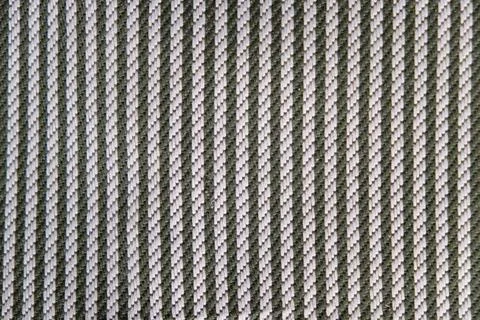 The surface of the texture of the fabric with weaving black and gray stripes. Stock Photos