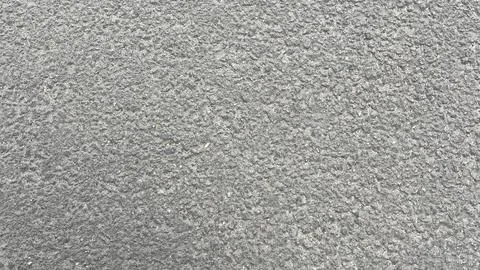 Surface texture of a gray concrete pavement displaying fine details and pat.. Stock Photos