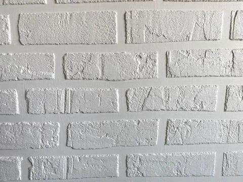 The surface texture of a homemade white loft-style brick wall with brick seam Stock Photos