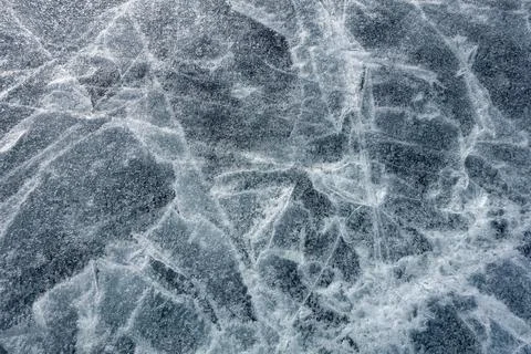 The surface texture of the ice. A cracked ice floe. Winter cold background Stock Photos