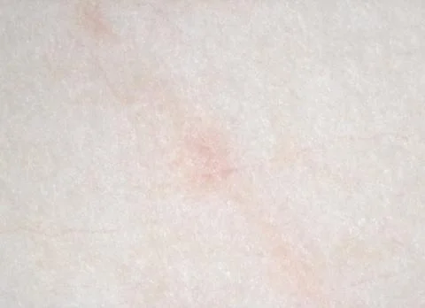 Surface texture of a marble stone with beige and pink tones Stock Photos