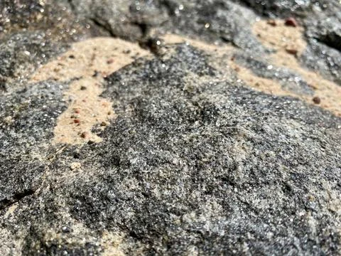 Surface texture of old scratched sharp stone natural gray with fine sand. The Stock Photos