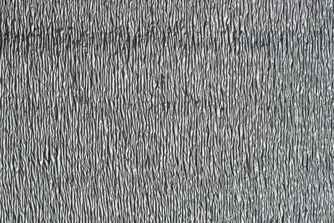 Surface texture of reflective metallic insulation material. Stock Photos