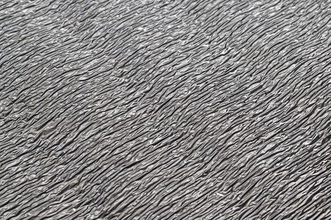 Surface texture of reflective metallic insulation material. Stock-Fotos