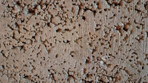 Surface of a textured wall showing many small holes and uneven spots Foto stock