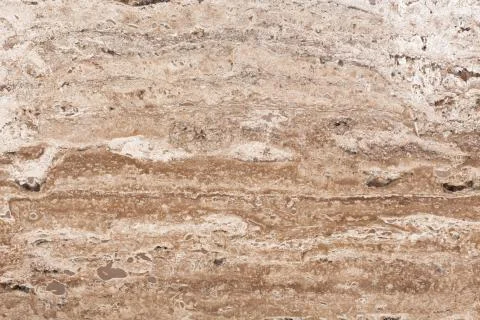 Surface of travertine stone in close-up. Abstract texture. Stock Photos