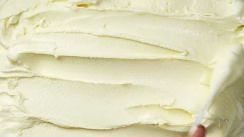 The surface of vanilla ice cream is spread with spatula Stock Footage 260327868
