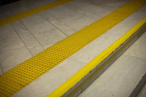 Surface for visually impaired. Yellow limiter for blind. Markings on stairs. Stock Photos