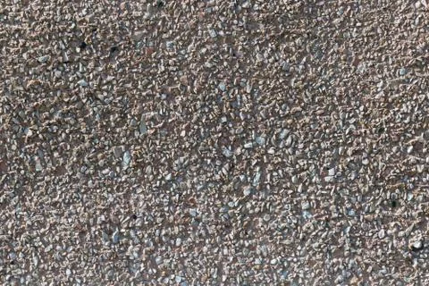 The surface of the wall of the building of a large number of small stones. Foto stock