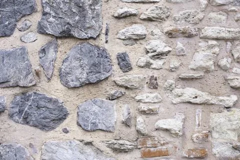 The surface of the wall is made of pink clay and rough marble Stock Photos