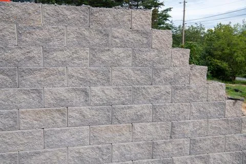 The surface of a wall or fence lined with gray bricks Stock Photos