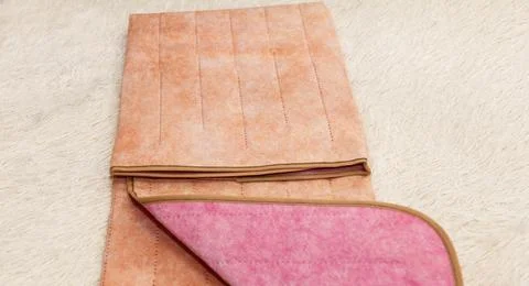Surface of a warm beauty two-sided electro sheet, laid out on bed, looks fr.. Stock Photos