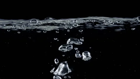 Surface of water on black background, air bubbles rise up. Slow motion shot of Stock-Footage 237616139