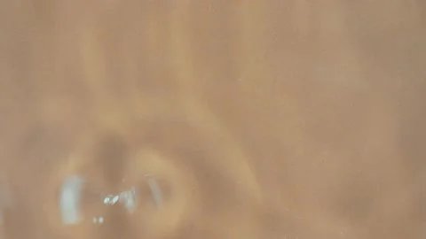 On the surface of water with drops. light brown background Stock Footage 220370002