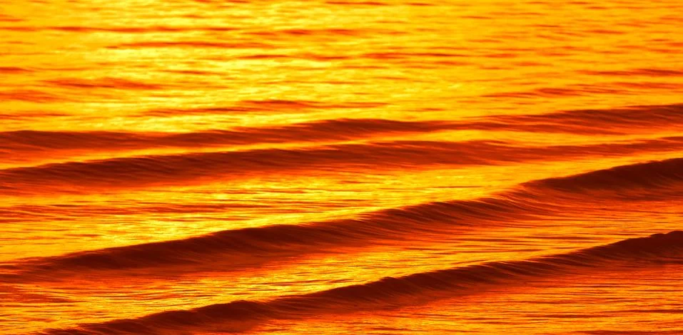Surface of water at sunset Stock Photos