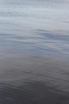 Surface of water under a cloudy sky in summer Stock Photos