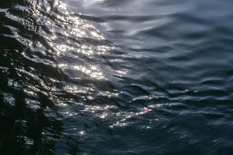 The surface of the water with waves of waves and gleaming waves. Abstract. Stock Photos