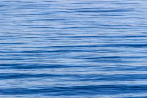 Surface with waves of the blue sea, background, texture Stock Photos