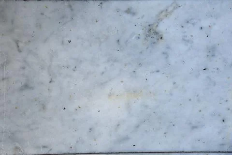 Surface of white marble with natural patterns and small speckles in various Stock Photos