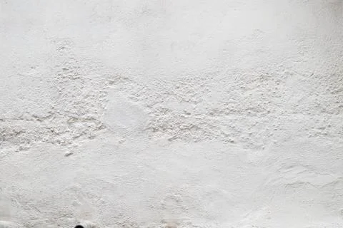 Surface of a white painted wall with roughness and cracks with copy space Stock Photos