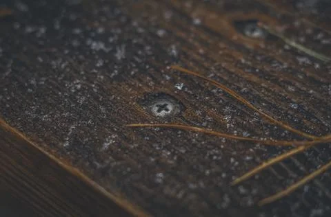 The surface of the wooden table is covered with the first snow and coniferous Stock Photos