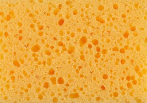 Surface of yellow sponge textured background close-up Stock Photos