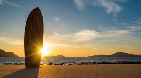 Surfboard on the beach at sunset Stock Photos