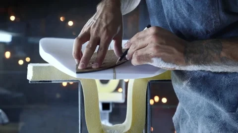 Surfboard making, Shaper measuring blank surfboard with a template. Stock Footage 131798854
