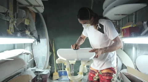Surfboard making, Shaper is shaving and cleaning a line on a surfboard Stock Footage 64410982