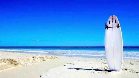 Surfboard Planted on Sand with Soft Waves Stock Footage 277465845