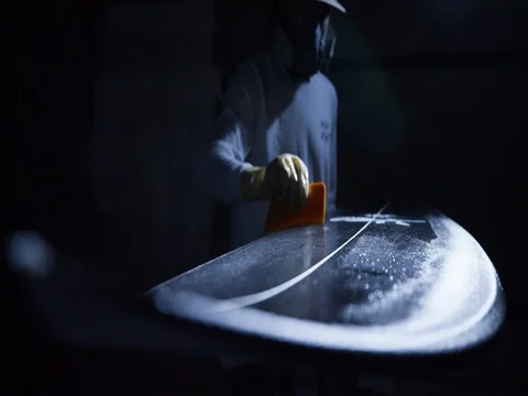 Surfboard Shaper glassing a surfboard Stock Footage 78312997