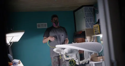 Surfboard shaper Man making a surfboard in a workshop Stock Footage 107639513