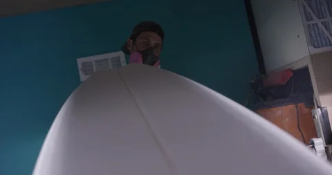 Surfboard shaper Man making a surfboard in a workshop Stock Footage 107639922