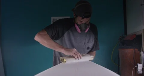 Surfboard shaper Man making a surfboard in a workshop Stock Footage 107640577