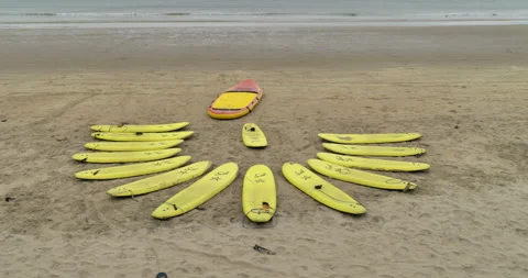 Surfboards on a beach in a semi circle Stock Footage 283393810