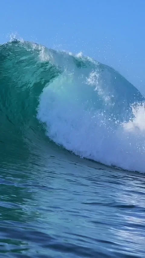Surfer and blue ocean wave at sunny day.Vertical video Stock Footage 296214006